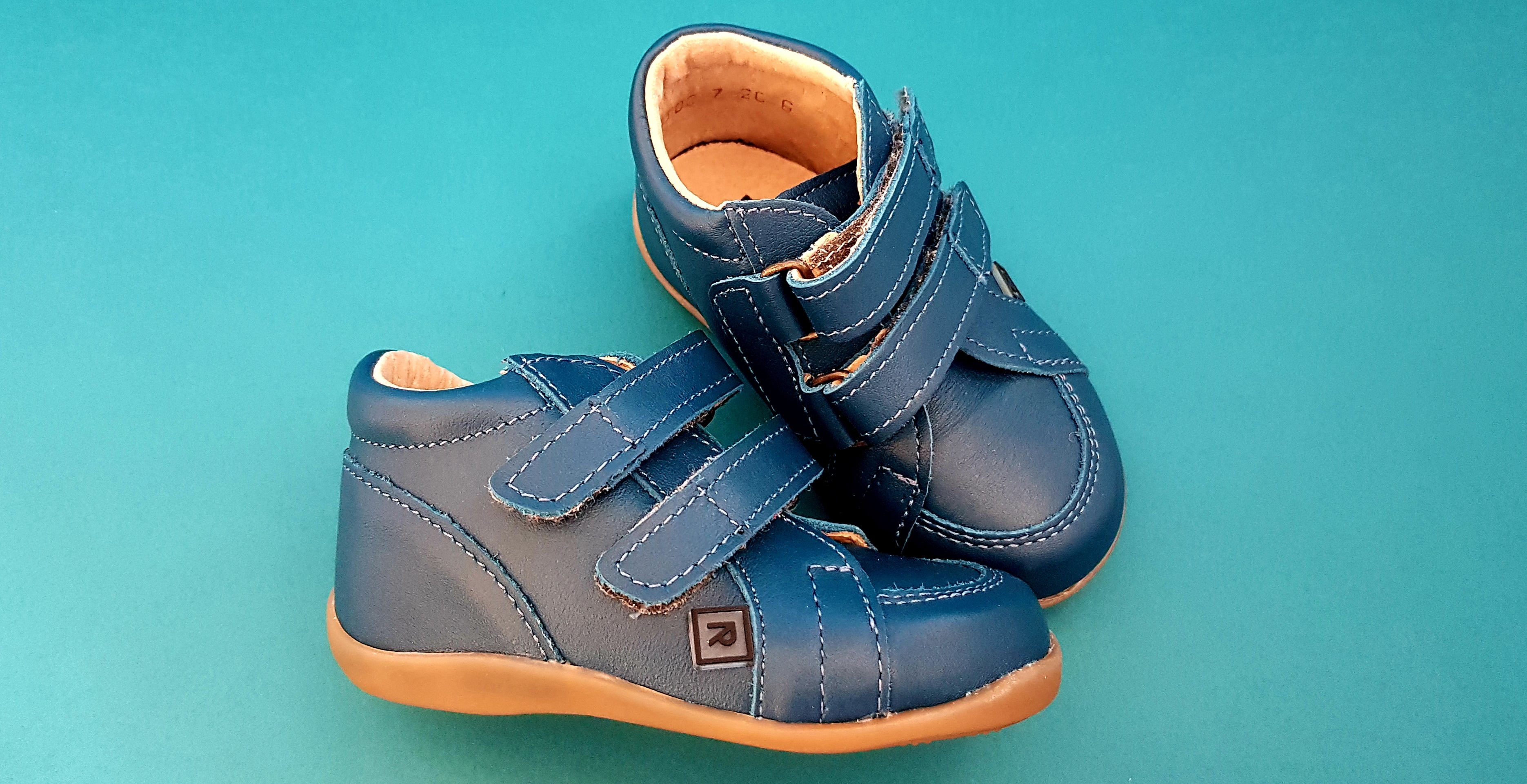 Dark Blue First Walking Shoes for Toddlers made from soft leather with hood-and-loop fastener, seen from top and sideways