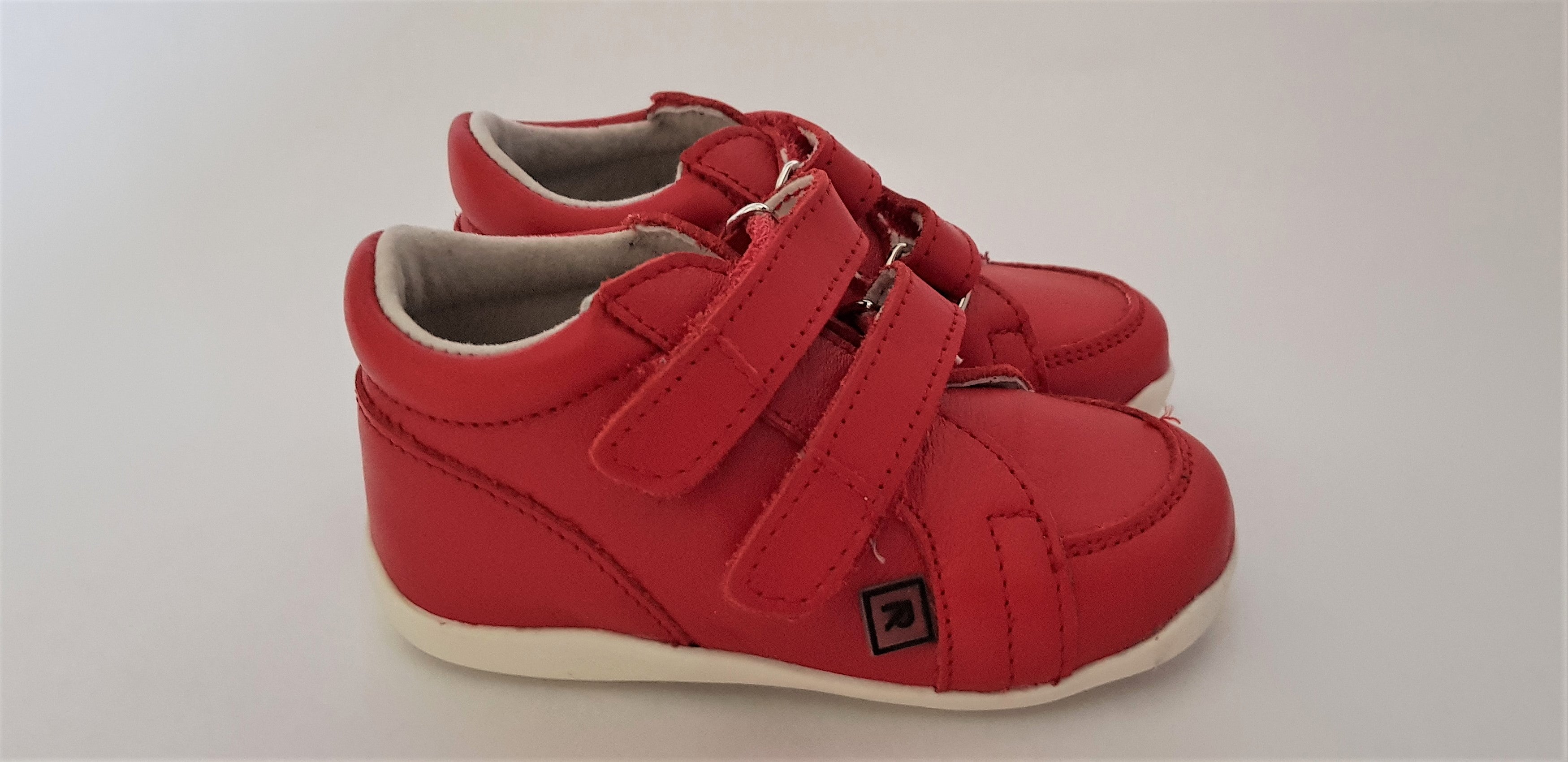 Red First Walking Shoes for Toddlers made from soft leather with hood-and-loop fastener and round toe box
