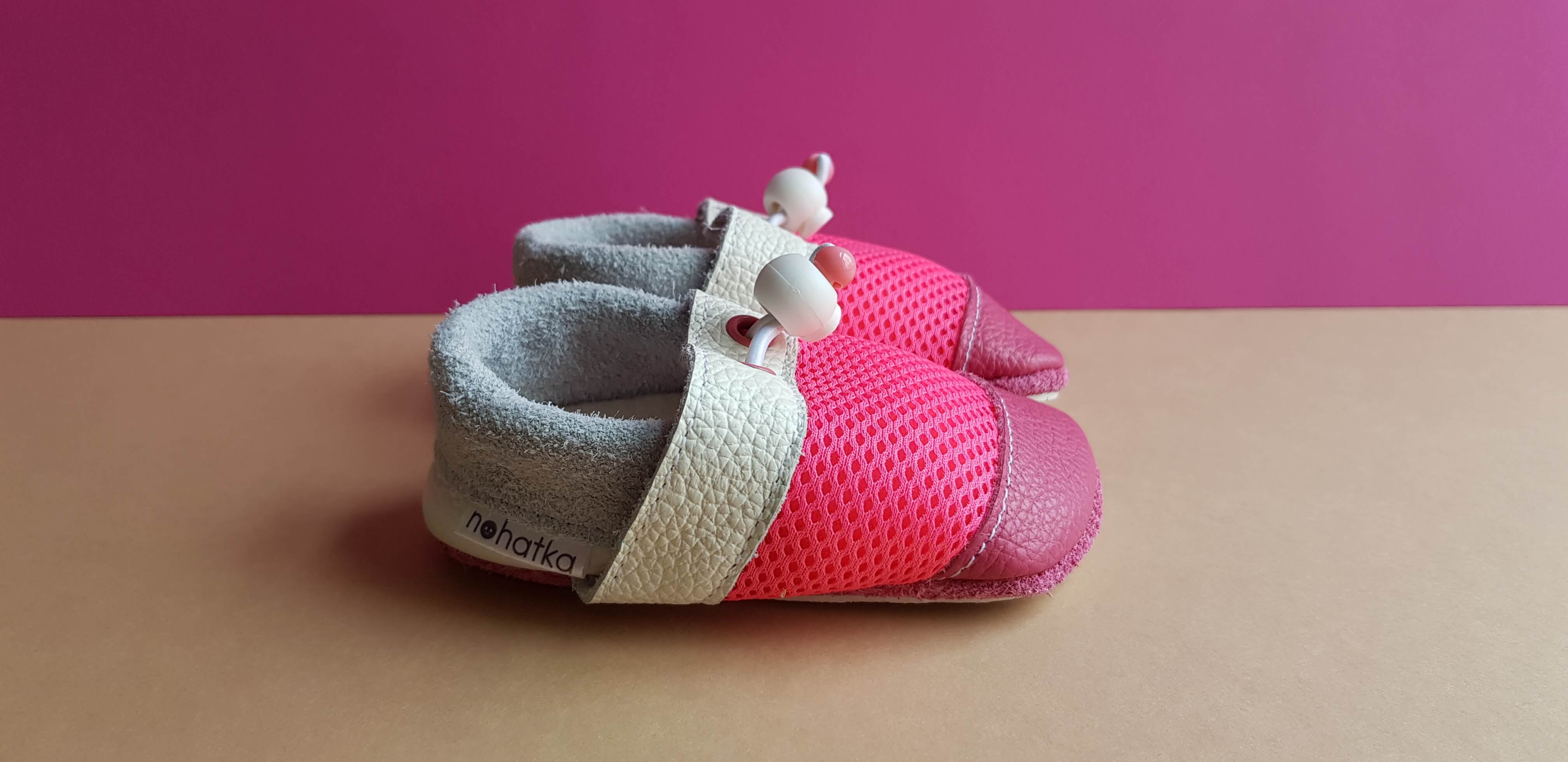 Pink and White Breathable Nohatka soft sole booties/slippers for babies and toddler, anatomically shaped from soft leather with adjustable ankle fastening and anti slip indoor/outdoor sole