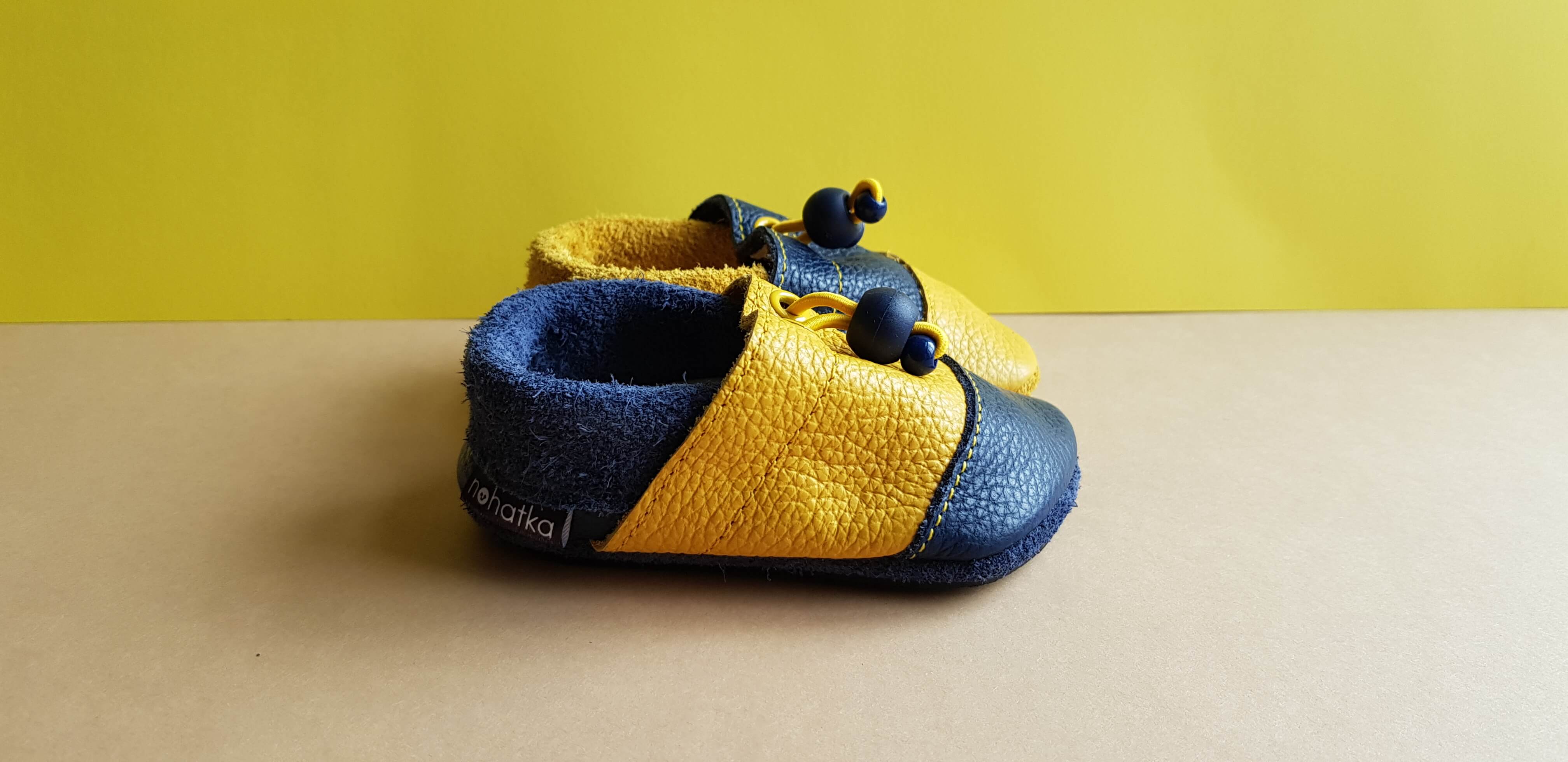 Navy and Yellow Nohatka soft sole booties/slippers for babies and toddler, anatomically shaped from soft leather with adjustable ankle fastening and anti slip indoor/outdoor sole